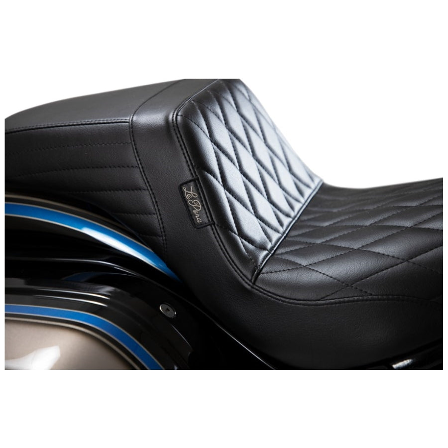 The Le Pera Kickflip Seat - Diamond - Black - FXLR, FXLRS, FXLRST, FLSB '18-'24 from the brand Le Pera features a sleek and stylish design. Crafted from black leather, this seat adds a touch of elegance to any motorcycle. Its diamond pattern adds a unique and luxurious element to the overall look.