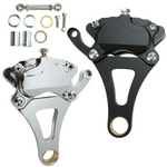 The Moto Iron® Brake Caliper Kit for Moto Iron Springer Front Ends includes two disc brake calipers—one 4-piston in chrome and one in black—with mounting hardware and bolts, displayed on a white background.