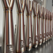 TC Bros. 2-into-1 Stainless Exhaust System for 2018-Up Harley-Davidson Softail by TC Bros., displayed with various Harley-Davidson Softail exhaust pipes in the background.