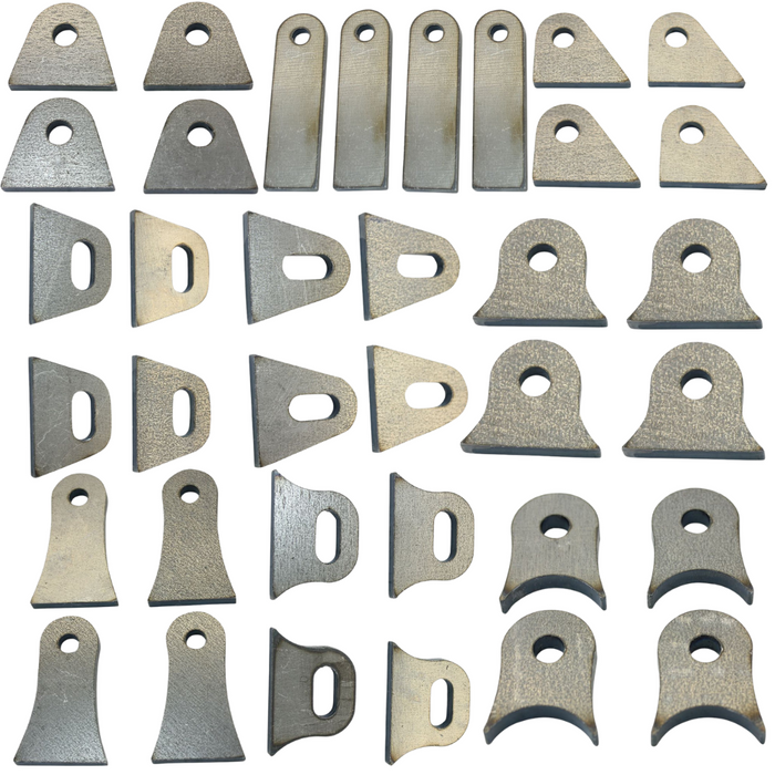 Thirty TC Bros. 1/4″ Steel Flat Mounting Tabs in assorted shapes and sizes with holes or slots, arranged in a grid on a white background—perfect for custom motorcycle fabrication or TC Bros. projects.