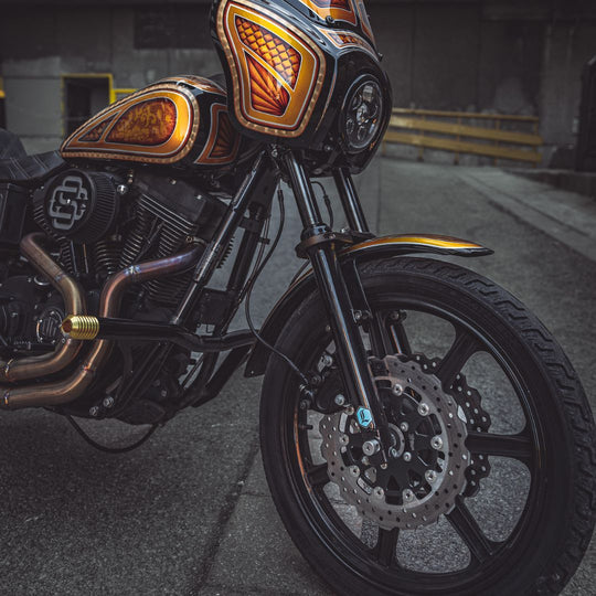 The TC Bros. 11.8" Profile Front Floating Brake Rotor for 2006-2025 Harley-Davidson features a black center with a silver, perforated, wave-patterned stainless steel surface for improved performance.