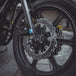 The TC Bros. 11.8" Profile Front Floating Brake Rotor for 2006-2025 Harley-Davidson features a black center with a silver, perforated, wave-patterned stainless steel surface for improved performance.