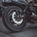 A close-up of the TC Bros. 11.5" Rear Floating Brake Rotor for 2000-2023 Harley-Davidson, featuring a black center hub and silver perforated outer ring in the distinctive TC Bros. profile.