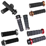 Two black Waffle Lock-On V-Twin Grips for Harley motorcycles with Throttle by Wire, featuring a textured design in black and graphite. These ODI grips, adorned with silver end caps and a metallic logo, add both style and comfort to your ride.