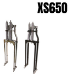 Two Moto Iron® Springer Front Ends for Yamaha XS650, one silver and one black, are displayed side by side on a white background with "XS650" in bold above them.