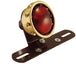 A red Mid-USA tail light with Brass Vintage Drilled Tail Light.