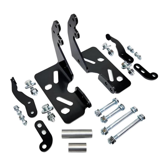 A Yamaha motorcycle engine is securely mounted on a Chop Source Deluxe Yamaha XS650 Engine Stand Brackets by Chop Source, positioned against a plain white wall.