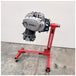 A Yamaha motorcycle engine is securely mounted on a Chop Source Deluxe Yamaha XS650 Engine Stand Brackets by Chop Source, positioned against a plain white wall.
