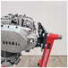 A Yamaha motorcycle engine is securely mounted on a Chop Source Deluxe Yamaha XS650 Engine Stand Brackets by Chop Source, positioned against a plain white wall.