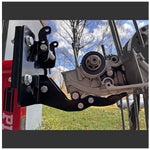 A Yamaha motorcycle engine is securely mounted on a Chop Source Deluxe Yamaha XS650 Engine Stand Brackets by Chop Source, positioned against a plain white wall.