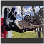 A Yamaha motorcycle engine is securely mounted on a Chop Source Deluxe Yamaha XS650 Engine Stand Brackets by Chop Source, positioned against a plain white wall.