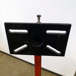 A Yamaha motorcycle engine is securely mounted on a Chop Source Deluxe Yamaha XS650 Engine Stand Brackets by Chop Source, positioned against a plain white wall.