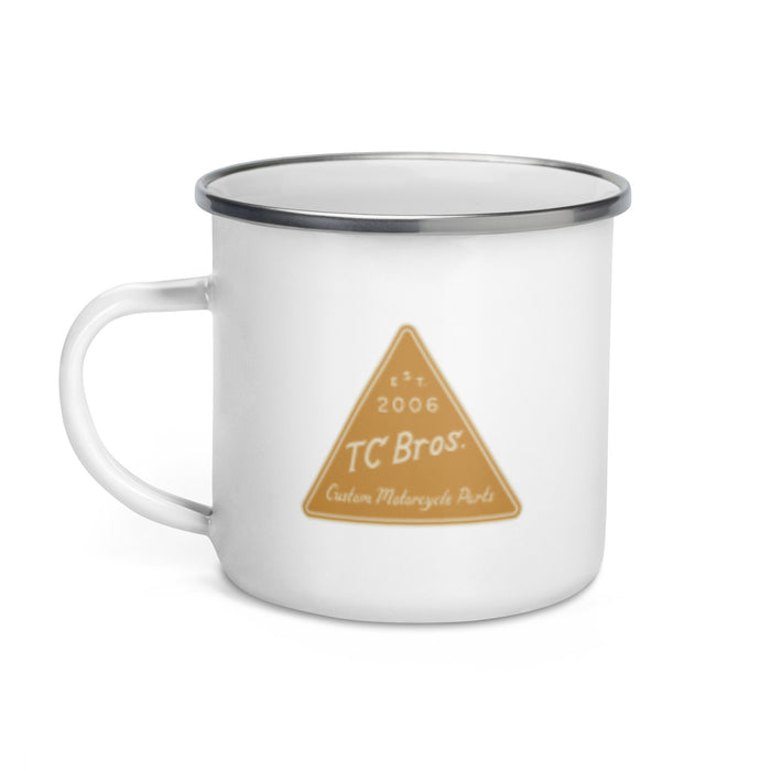 An TC Bros. Metal Camp Mug - White Enamel Coated - 12oz with a TC Bros. custom motorcycle parts logo printed on it.