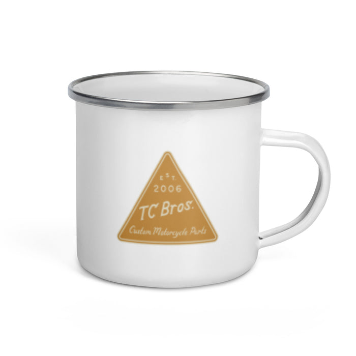 An TC Bros. Metal Camp Mug - White Enamel Coated - 12oz with a TC Bros. custom motorcycle parts logo printed on it.