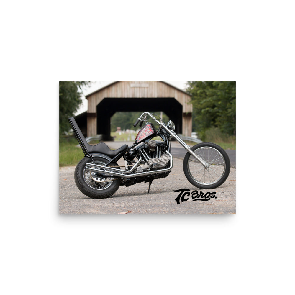 Custom motorcycle with a TC Bros. Old School Sportster Poster parked in front of a wooden barn, printed on thick matte paper.