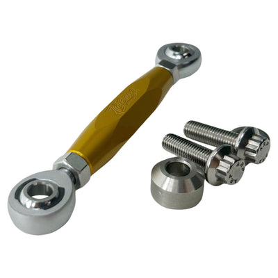 The TC Bros. M8 Softail Adjustable Brake Linkage for Mid Controls includes three adjustable rod end bearings in black, gold, and silver, each with engraved branding. Ideal for Harley Davidson M8 Softail mid controls, the set comprises two bolts, two lock nuts, and two washers for precise adjustments.