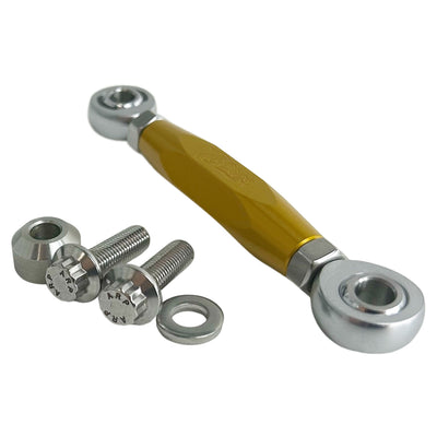 The TC Bros. M8 Softail Adjustable Brake Linkage for Mid Controls includes three adjustable rod end bearings in black, gold, and silver, each with engraved branding. Ideal for Harley Davidson M8 Softail mid controls, the set comprises two bolts, two lock nuts, and two washers for precise adjustments.