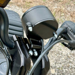Two black metal mounting brackets for the TC Bros. Gauge Relocation Bracket for 2022-Up Harley-Davidson Nightster, shown with screws, washers, and nuts on a white background.