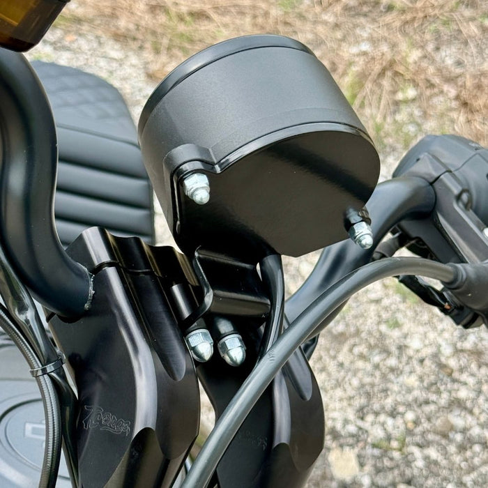Two black metal mounting brackets for the TC Bros. Gauge Relocation Bracket for 2022-Up Harley-Davidson Nightster, shown with screws, washers, and nuts on a white background.