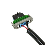The Namz Speedometer/Cluster Extension Harness for 2022-Up Harley-Davidson Nightster is a black harness with two connectors and a green component, ideal for your bike.