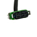 The Namz Speedometer/Cluster Extension Harness for 2022-Up Harley-Davidson Nightster is a black harness with two connectors and a green component, ideal for your bike.
