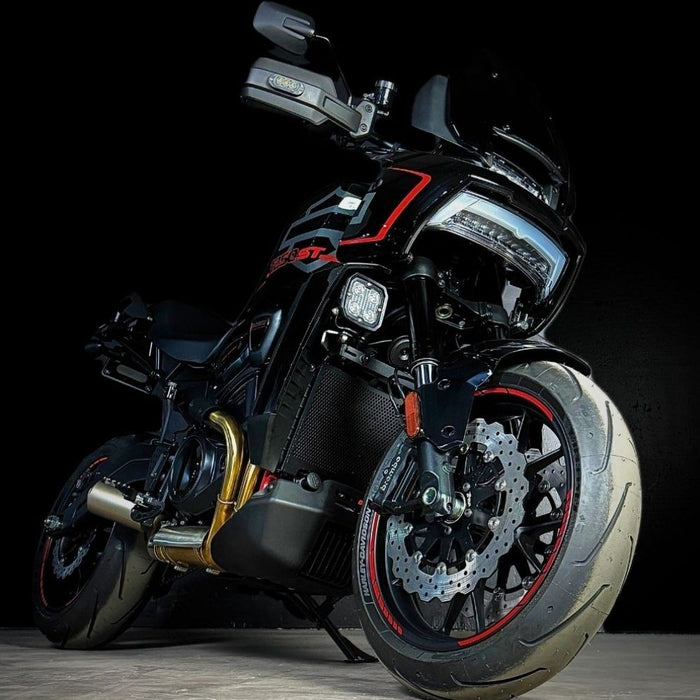 The TC Bros. Profile™ Front Floating Brake Rotor, compatible with 2023+ Harley Touring Bagger and 2021+ Pan America models, features a perforated round design crafted from high-carbon stainless steel with a black center and silver edge.