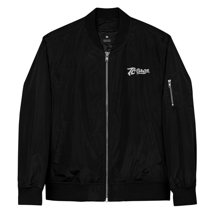 TC Bros. black bomber jacket, made of recycled polyester, with zipper and logo on the left chest.