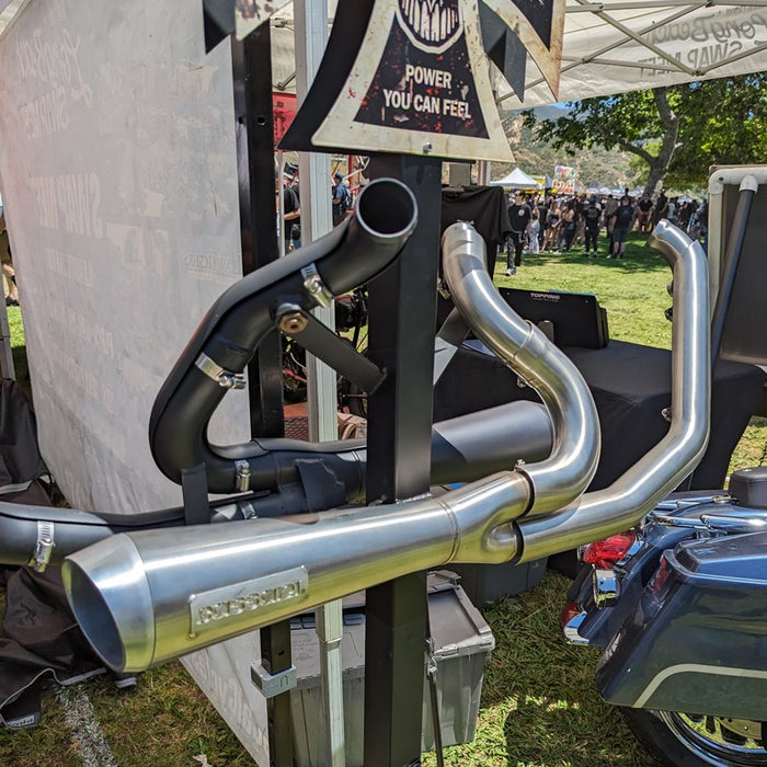 A black motorcycle with gold accents, featuring a windshield, large exhaust pipe, and spoke wheels fitted with a Bassani The Ripper Road Rage 2-into-1 Stainless Exhaust 06-17 FXD (w/Mids), 07-17 FXD/FXDWG (w/Forwards).