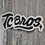 A TC Bros. Metal Shop Sign - Stamped Aluminum with the word "icons" in a cursive font, affixed to a textured gray stamped aluminum surface.