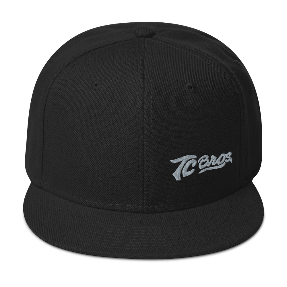 Black Script Flat Bill Snapback Hat with a TC Bros. logo on the front, printed on demand.