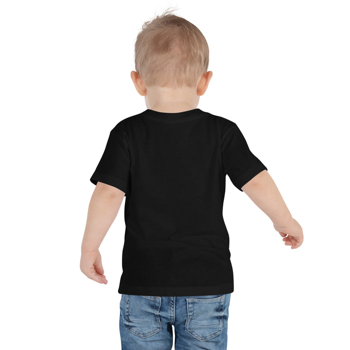 Toddler wearing a TC Bros. Winged Wheel Black/Gold cotton t-shirt, paired with jeans.