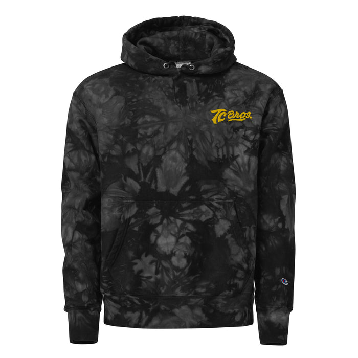 A black and gray camouflage patterned TC Bros. tie-dye hoodie with a yellow logo on the left chest.