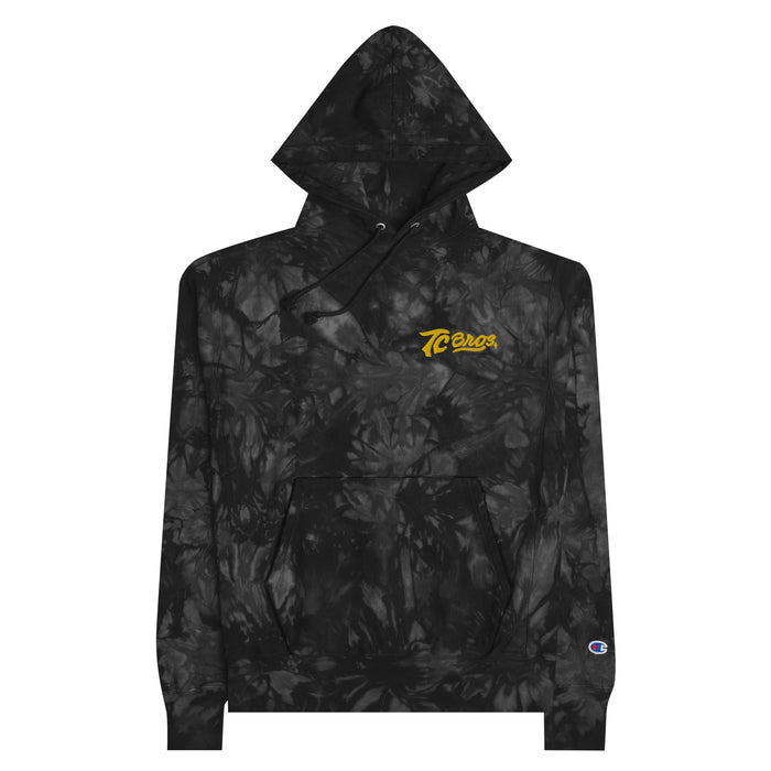 A black and gray camouflage patterned TC Bros. tie-dye hoodie with a yellow logo on the left chest.