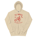 Beige Rider Hoodie - Sand featuring a red graphic of a motorcycle and text advertising TC Bros. custom motorcycle parts, printed on demand.