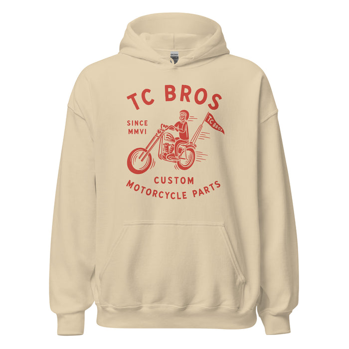 Beige Rider Hoodie - Sand featuring a red graphic of a motorcycle and text advertising TC Bros. custom motorcycle parts, printed on demand.