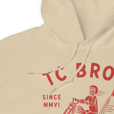 Beige Rider Hoodie - Sand featuring a red graphic of a motorcycle and text advertising TC Bros. custom motorcycle parts, printed on demand.