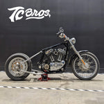 The TC Bros. Weld-On Hardtail Kit for 2004-2013 Harley-Davidson Sportster includes a frame, bracket, bolts, washers, and small hardware components—all neatly displayed on a white background.