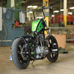 A TC Bros. motorcycle parked in a warehouse.