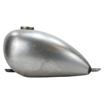 The Moto Iron® 2.3 Gallon Wassell-Style Low Tunnel Frisco-Style Fuel Tank features a matte silver metal finish, rounded teardrop shape, and minor surface scratches visible on the side.