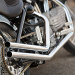 Moto Iron® Upsweep Exhaust System for Harley-Davidson Sportster 1986-2003 shown in chrome with mounting brackets and hardware, ideal for adding custom chopper style. Displayed on a white background.