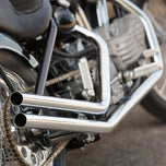Moto Iron® Upsweep Exhaust System for Harley-Davidson Sportster 1986-2003 shown in chrome with mounting brackets and hardware, ideal for adding custom chopper style. Displayed on a white background.