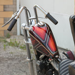 Moto Iron® 2.1 Gallon Narrow Sportster Frisco-style Fuel Tank, unpainted metal with open fuel cap, shown on a white background—ideal for chopper and custom bike fans.