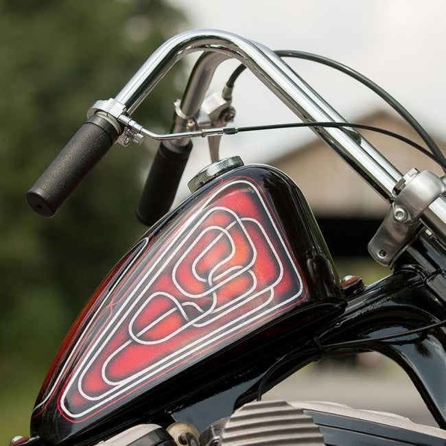 A close up of the handlebars of a Harley Davidson motorcycle with TC Bros. 1" Rabbit Handlebars - Chrome.