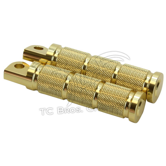 A pair of HardDrive Brass Knurled Foot Pegs For Harley Models 2017-Earlier on a white background with CNC machined details.