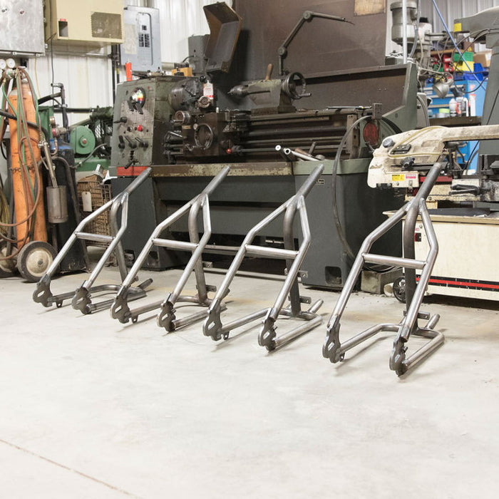 A machine shop with a lot of metal equipment, including the Sportster Hardtail Kit for 1982-2003 by TC Bros. (Weld On) fits Stock 130-150 Tire and Harley Sportster Hardtail kit by TC Bros.