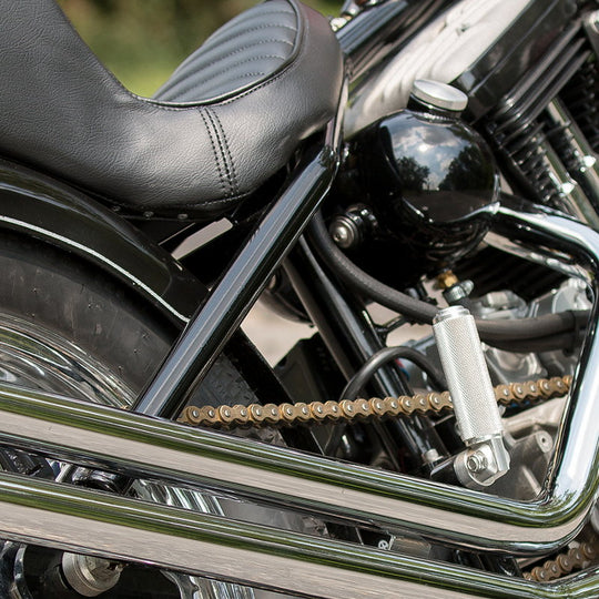 A close up of the TC Bros 5 inch Round Pill Style Chopper Oil Tank Universal Fit on a universal fit motorcycle.