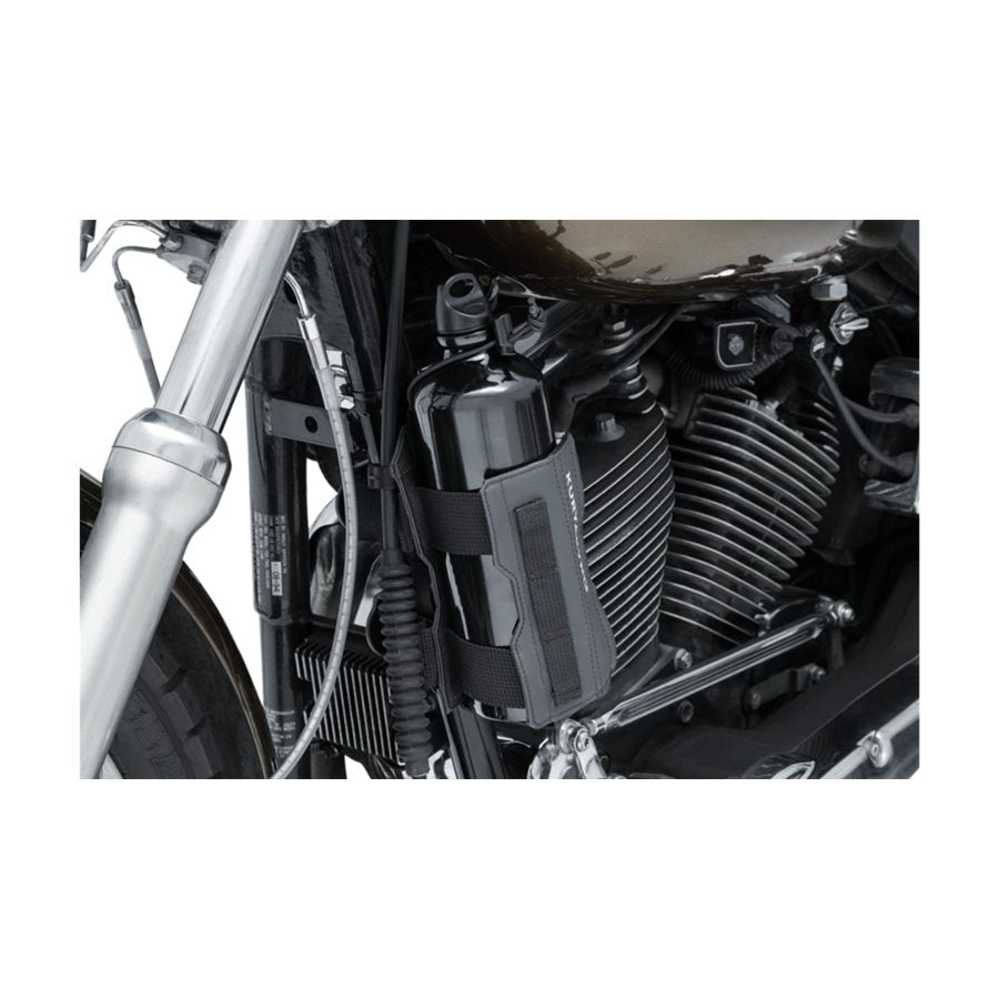 A close up of a motorcycle engine featuring a KURYAKYN Clinger Fuel Bottle Holder.