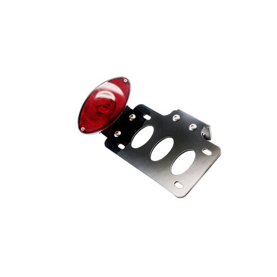 A TC Bros. Cat Eye Side Mount Tail Light/License Plate Bracket mounted on a white background with a universal design.