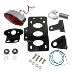 A set of TC Bros. Cat Eye Side Mount Tail Light/License Plate Bracket with a red tail light bracket.