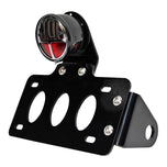 A TC Bros. "Stop" Bobber Side Mount Tail Light/License Plate Bracket with a versatile bracket.